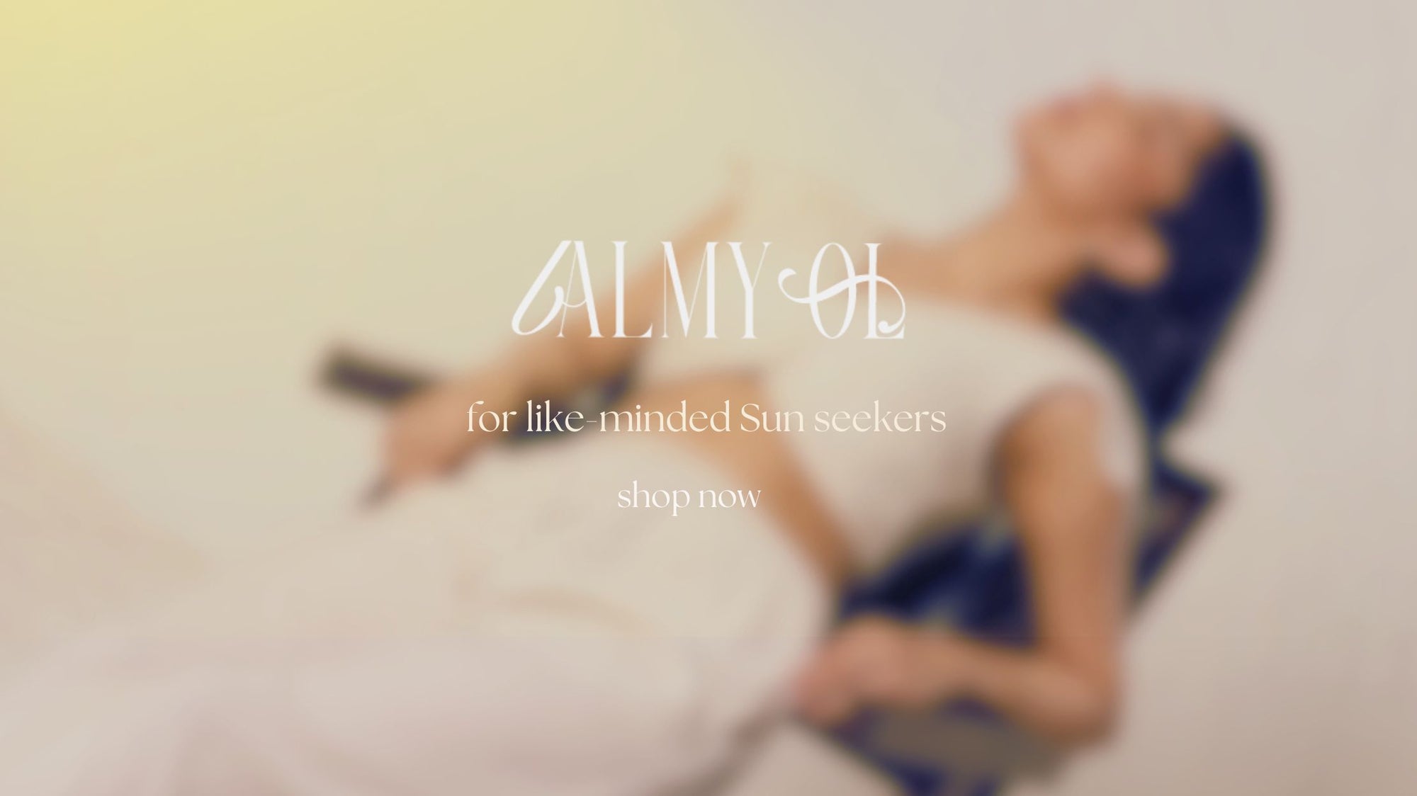Blurred image of a person lying on a beach with 'ALMYOL' branding and text.