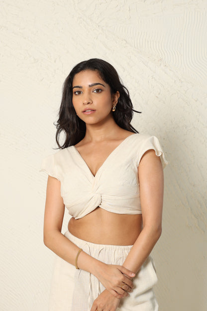Woman wearing a beige top with a textured white background