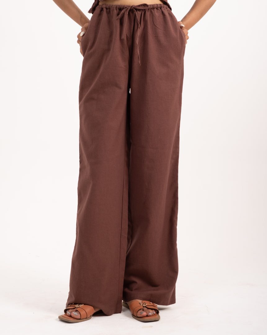 Brown wide-leg pants worn by a person on a white background