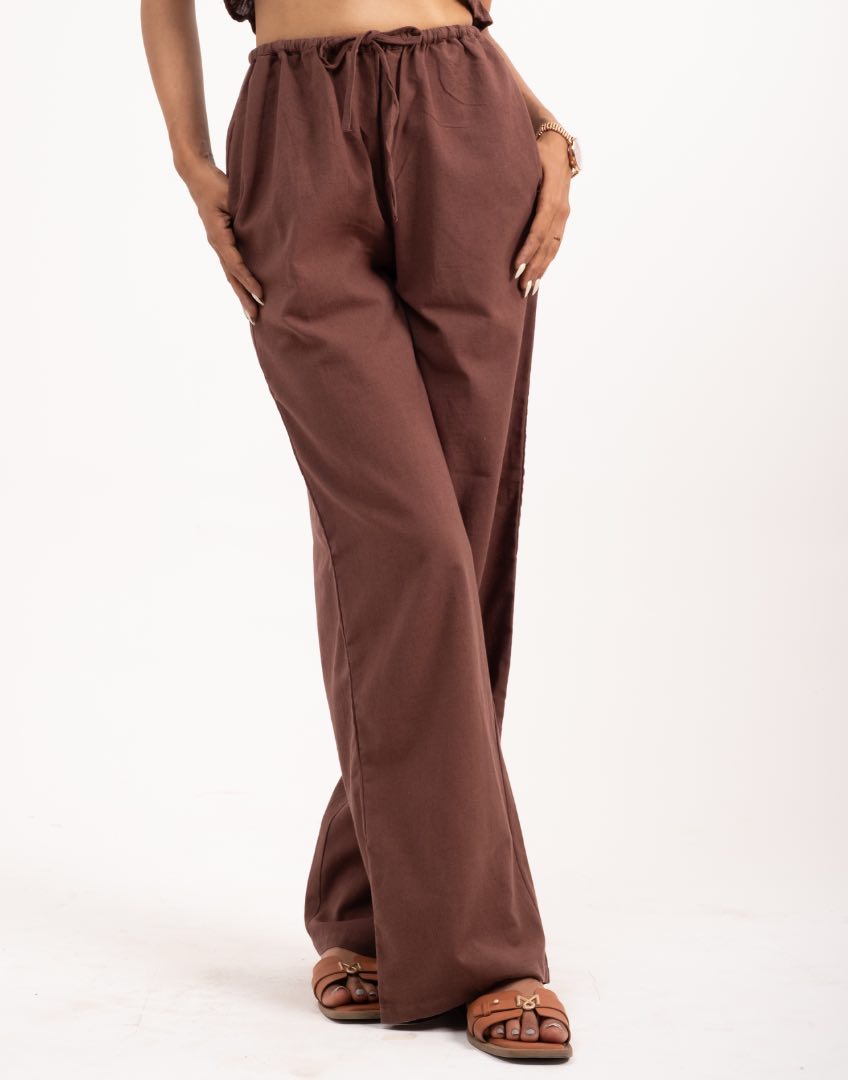 Brown wide-leg pants worn by a women on a white background