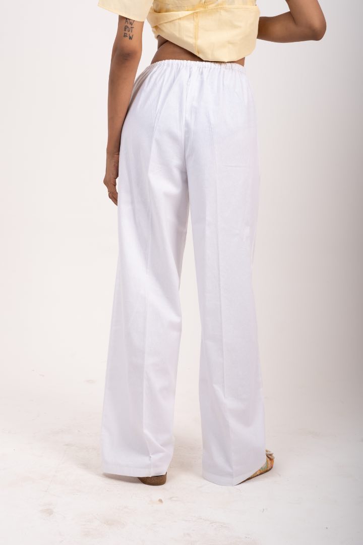 White wide-leg pants worn by a woman on a white background