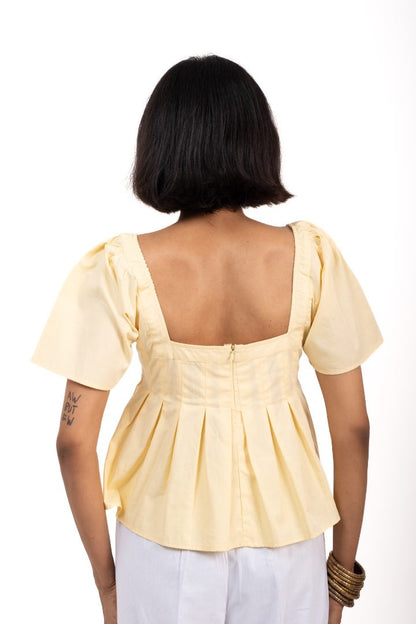 Woman wearing a light yellow top